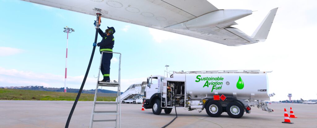 Aircraft being refueled with sustainable aviation fuel on an airport runway, highlighting eco-friendly aviation solutions and renewable energy in air transport.