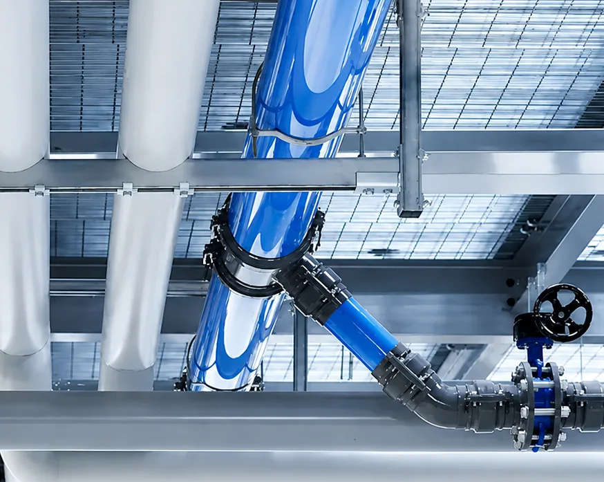Overhead blue aluminum piping system for compressed air distribution in an industrial installation.
